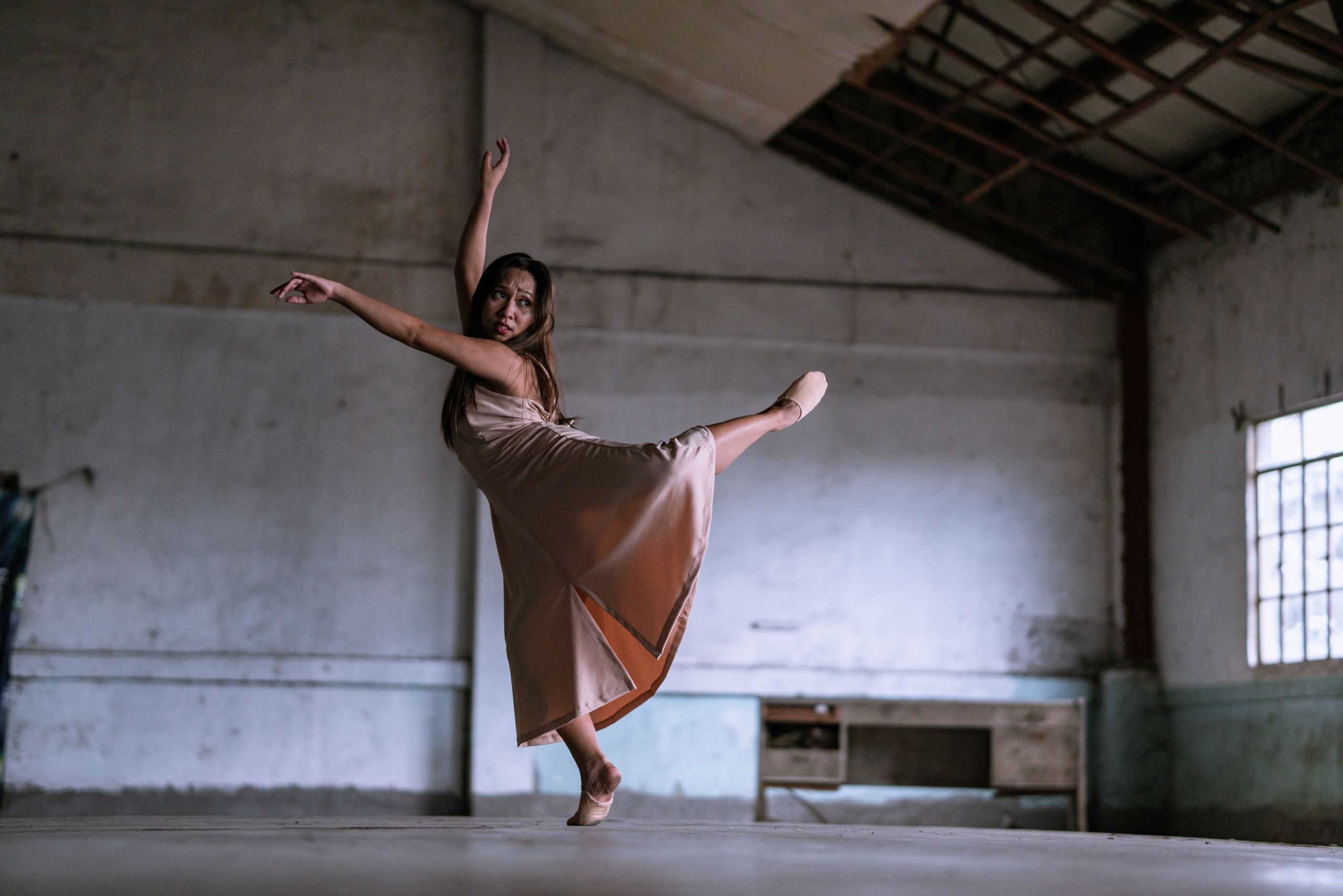 Ballet dancer gracefully performing in an industrial setting, showcasing contemporary dance artistry.
