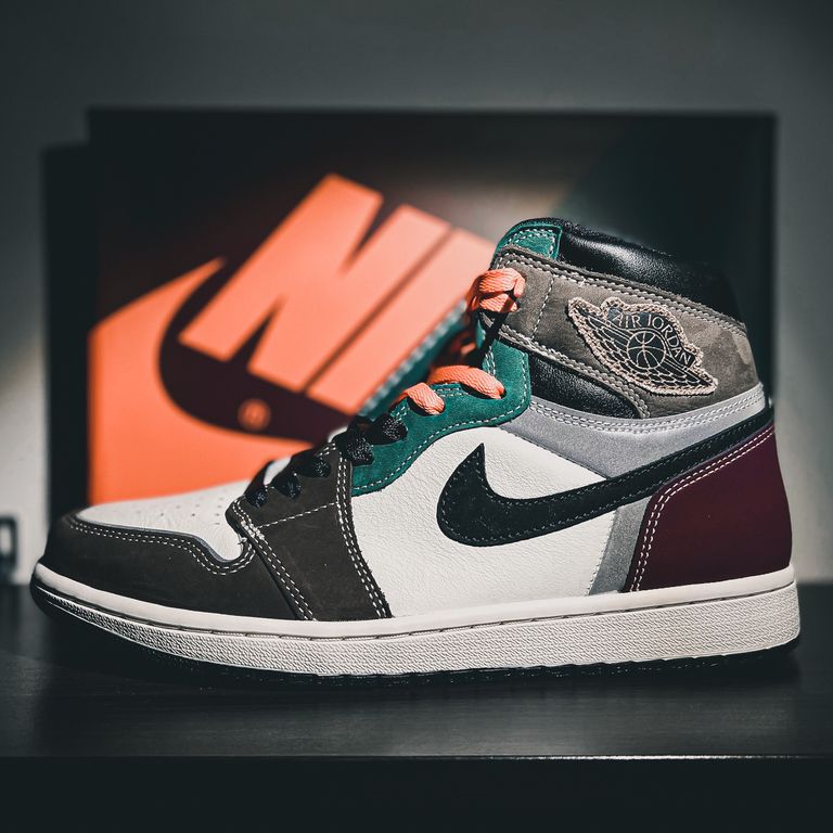High-cut Nike Air Jordan 1 sneaker with unique multi-color design on display with iconic branding.